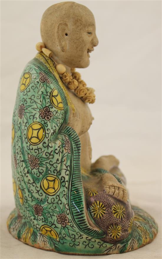 Chinese famille verte glazed biscuit seated figure of Luohan, 18th century(-)